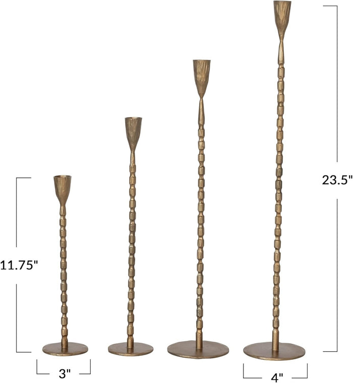 A close-up of the CREATIVE COOP CAST IRON TAPER HOLDER IN BRASS FINISH, EXTRA LARGE, featuring a textured vertical ribbed pattern and a rounded tapered cup at the top, set against a plain white background.