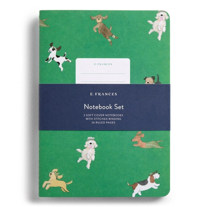 The E. FRANCES - STITCHED NOTEBOOKS OFF LEASH, SET OF 2 by E. FRANCES PAPER features one notebook with green stripes and a dog illustration, and another adorned with playful pups—perfect for pet lovers’ stationery needs.