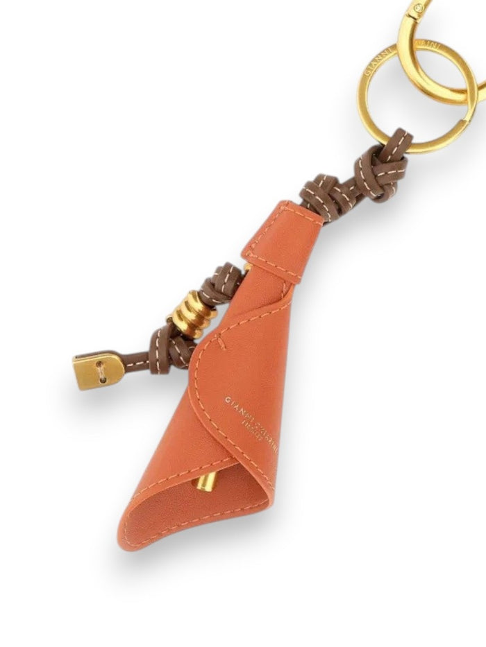 The GIANNI CHIARINI CALIA Charm Key Ring/Bag Charm features orange leather with gold and brown hardware, including a padlock, key, ring, and Calla charm, set against a white background.