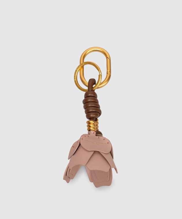 The GIANNI CHIARINI Dessert Flower Key Ring/Bag Charm features a gold clasp, brown accent coil, and pink leather layered petals—ideal as a stylish bag accessory. Set against a light gray background.