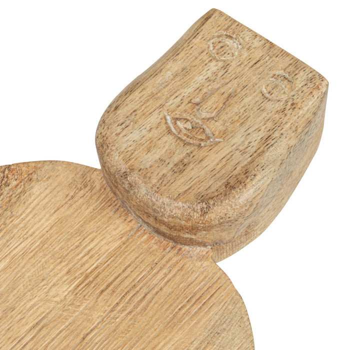 The CREATIVE COOP HAND-CARVED MANGO WOOD CHARCUTERIE/CUTTING BOARD WITH FACE HANDLE features a flat, rectangular shape, rounded edges, and rustic grain patterns for a handcrafted look.