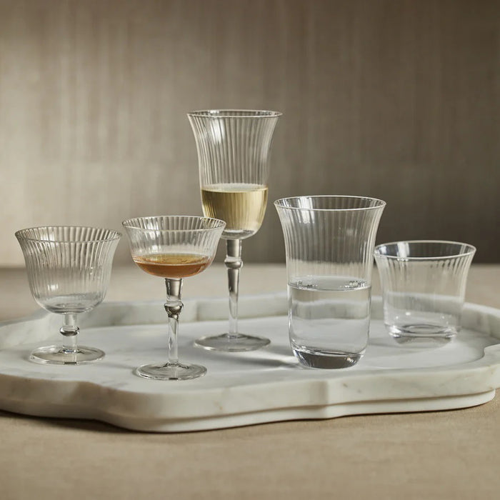 The ZODAX JULIEN CLEAR OPTIC WINE GLASS features a fluted bowl and long, slender stem, standing upright on a white background—perfect for serving wine from a 300 ml bottle.