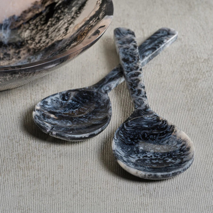 The KRONE RESIN SALAD SERVER SET by ZODAX features two black and gray marbled servers with round bowls and straight handles, displayed side by side on a white background for a contemporary touch.