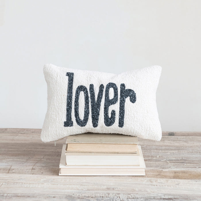 The “LOVER” LUMBAR PILLOW by CREATIVE COOP is a cream-colored cotton slub accent pillow with “lover” in bold black lowercase letters, perfect as a charming decorative piece.