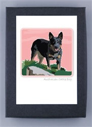 PAPER RUSSELLS - AUSTRALIAN CATTLE DOG NOTE CARDS feature an Australian cattle dog on grass with a pink sky, displayed in a black frame. Printed on recycled paper and proudly made in the USA by PAPER RUSSELLS.