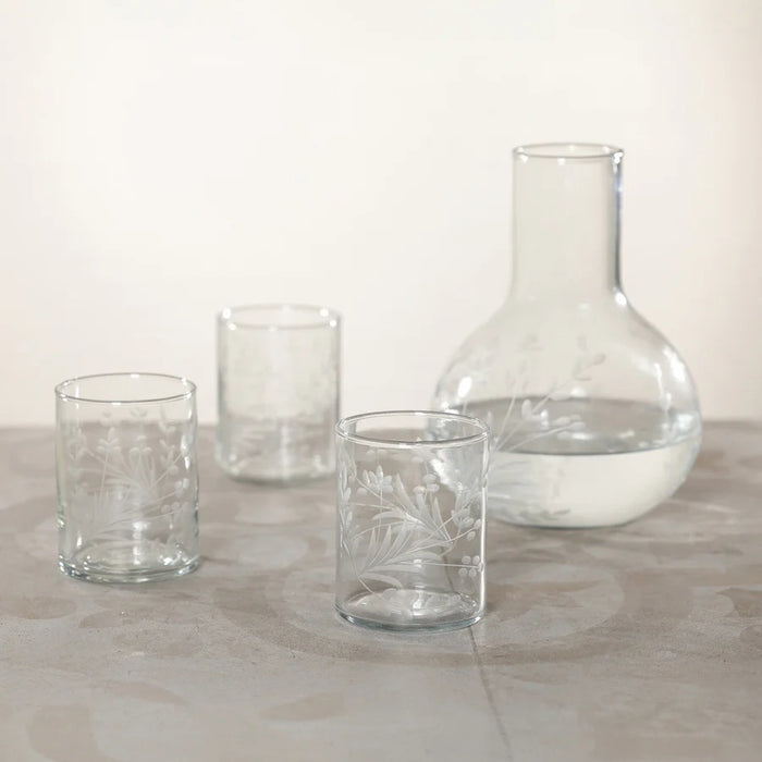 The ZODAX SHIRAZ TUMBLER features an etched flower design on its clear cylindrical surface, displayed against a plain white background.