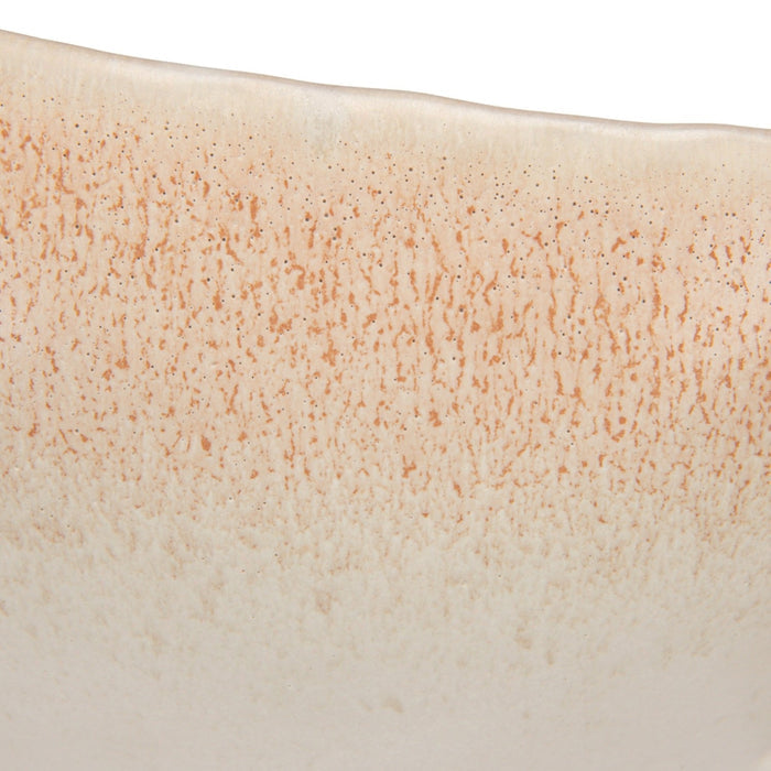 A close-up of the CREATIVE COOP WHITE SPECKLED BIRD-SHAPED STONEWARE FOOTED BOWL, featuring a gull-inspired design with a long beak and a smooth beige and light brown reactive glaze.