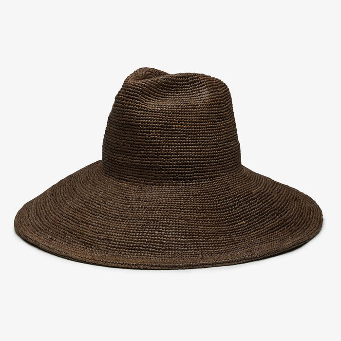 The WYETH Lina Raffia Sun Hat in Chocolate features a packable, ultra wide brim and slightly pointed crown, shown against a plain white background.