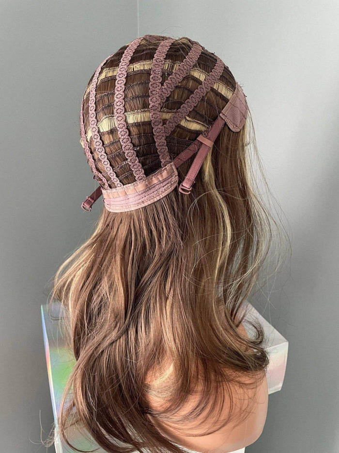Brown wig with a lace front on a mannequin head against a gray background