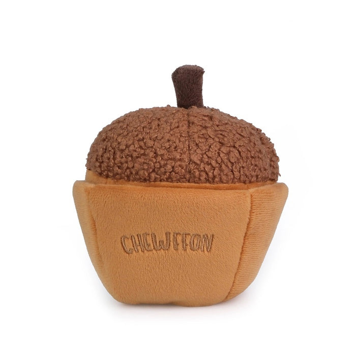 A plush, squeaky dog toy from CHEWFFON shaped like an acorn, featuring a textured brown top and a smooth tan base. The word “CHEWFFON” is embroidered on the base in light brown thread. This toy is called the ACORN SNUFFLE & SQUEAKY DOG TOY.