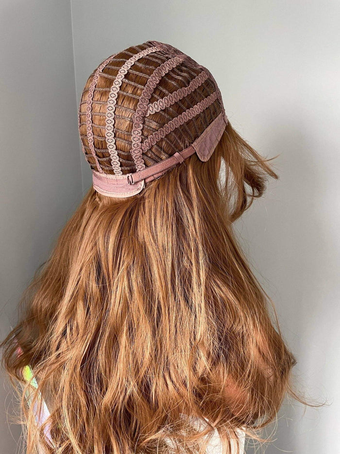 Brown hair with a textured headband against a neutral background