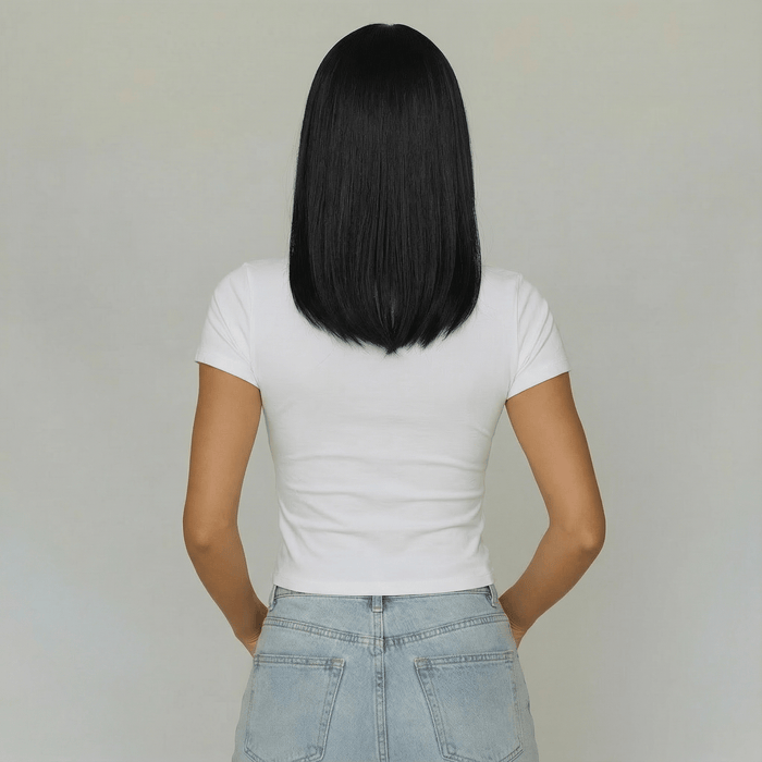 Short black wig with bangs showcased on a model wearing a white t-shirt from the back.
