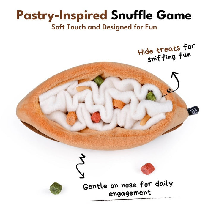 Introducing the CHOCOLATE ÉCLAIR SNUFFLE & CRINKLE DOG TOY by CHEWFFON—a plush dog toy shaped like a chocolate éclair with tan and brown fabric, topped with white squiggly lines resembling icing. This interactive dog toy features snuffle and crinkle elements for extra fun during playtime, making it perfect for pups who love cuddle-worthy companions.