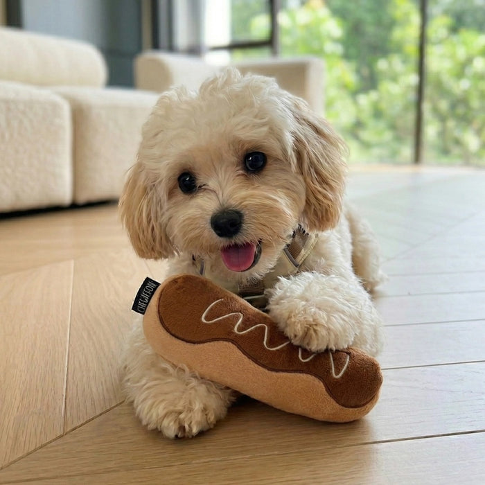 Introducing the CHOCOLATE ÉCLAIR SNUFFLE & CRINKLE DOG TOY from CHEWFFON—a plush, pastry-inspired enrichment toy featuring a soft white interior. This interactive dog toy is gentle on noses and designed for hiding small, colorful treats, encouraging your pup to sniff and search for rewards.