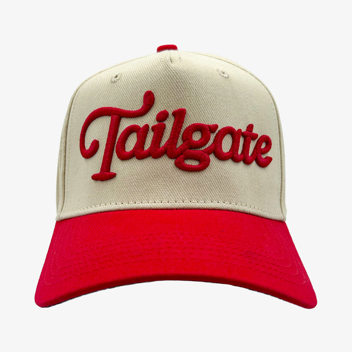 A baseball cap with an off-white crown and a bright red brim, featuring the word 'Tailgate' embroidered in red script across the front.