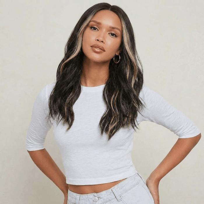Dani Black Bodywave Wig with Blonde Highlights styled on a model, showcasing soft waves and a modern middle part.