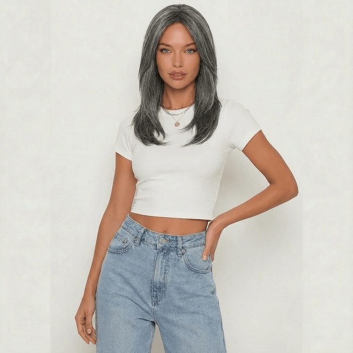 Dark grey layered wig modeled by a woman in a cropped white tee and high-waisted jeans, showcasing elegant style.