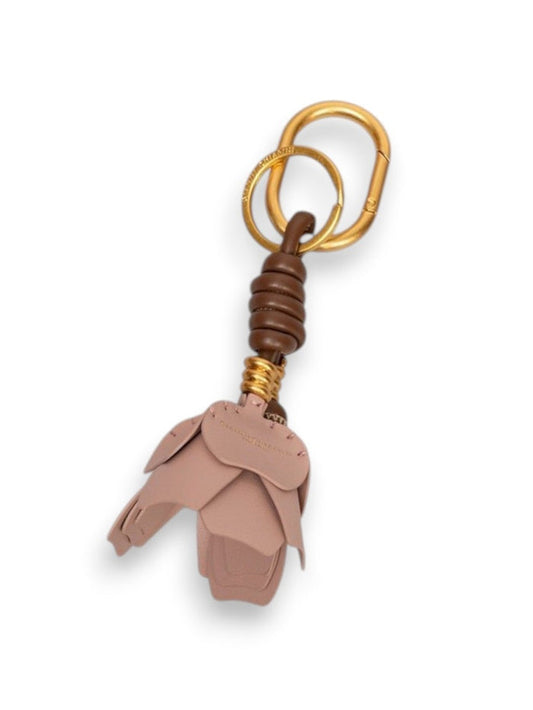 The GIANNI CHIARINI Dessert Flower Key Ring/Bag Charm features a gold clasp, brown accent coil, and pink leather layered petals—ideal as a stylish bag accessory. Set against a light gray background.