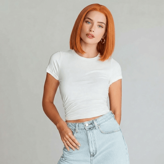 Model wearing Koi Orange Bob Lace Front Wig with blunt cut and natural middle, showcasing vibrant colour and sophistication.