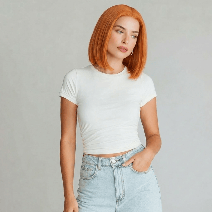 Model showcasing the Koi orange bob lace front wig with a sleek blunt cut and vibrant copper shade.