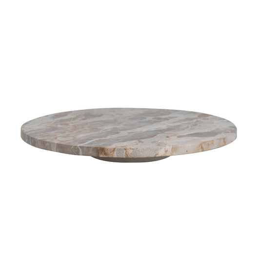 The CREATIVE COOP MARBLE LAZY SUSAN features a round, flat design with light brown and beige veining, displayed on a white background. Its slightly raised base creates an elegant elevated look—perfect as a kitchen centerpiece for entertaining.