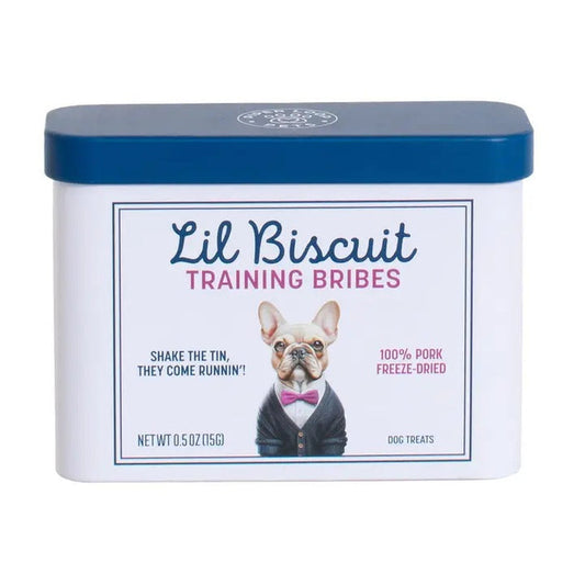 A rectangular white tin with a blue lid labeled "PIPER LOOP PETS - LIL BISCUIT TRAINING BRIBES, FREEZE-DRIED PORK" features a suited dog and promotes freeze-dried pork treats, ideal for training rewards or emergency recalls.