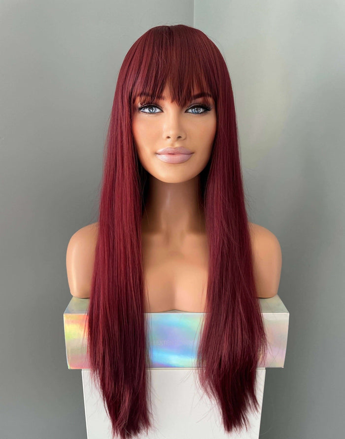 Long wine red silky straight wig with bangs displayed on a mannequin bust against a neutral background.