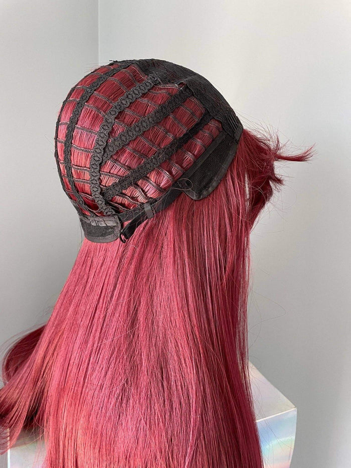 Long wine red silky straight wig with bangs showing the interior cap construction and natural flow of the hair.
