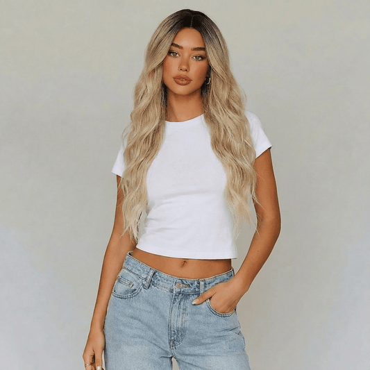 Model wearing Shannon long blonde lace front wig with beach waves and casual white top.