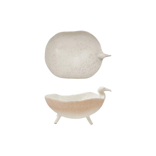 A close-up of the CREATIVE COOP WHITE SPECKLED BIRD-SHAPED STONEWARE FOOTED BOWL, featuring a gull-inspired design with a long beak and a smooth beige and light brown reactive glaze.